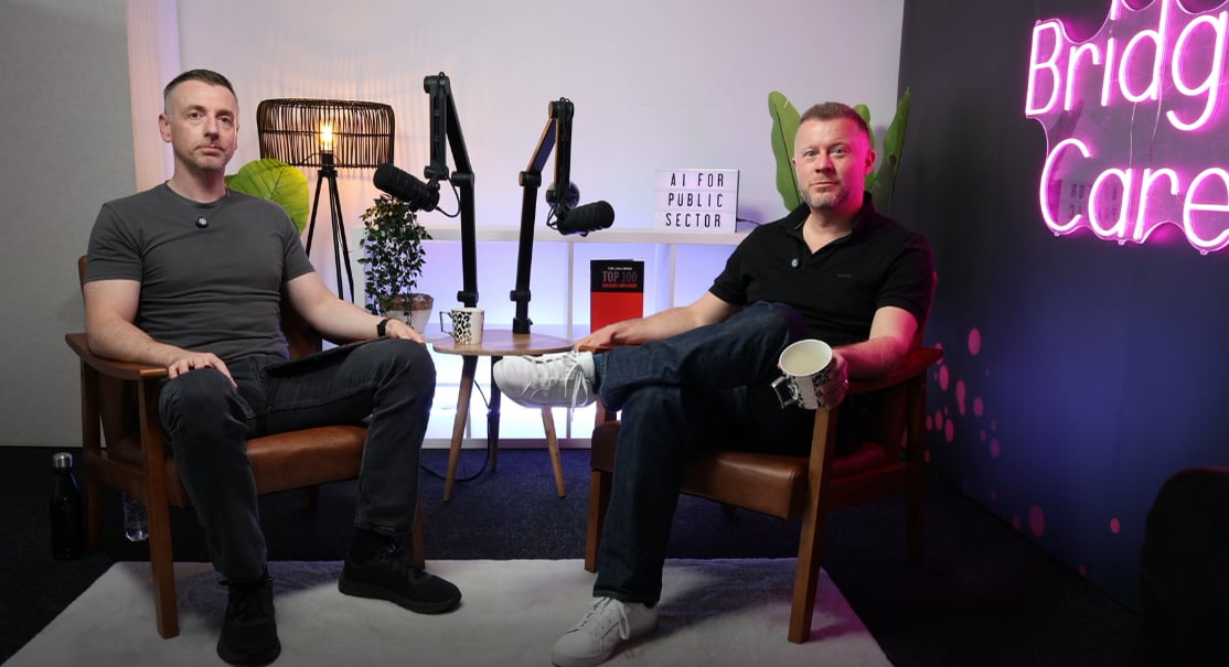 Darren and Wayne seated with microphones in the Bridgit Care podcast studio.